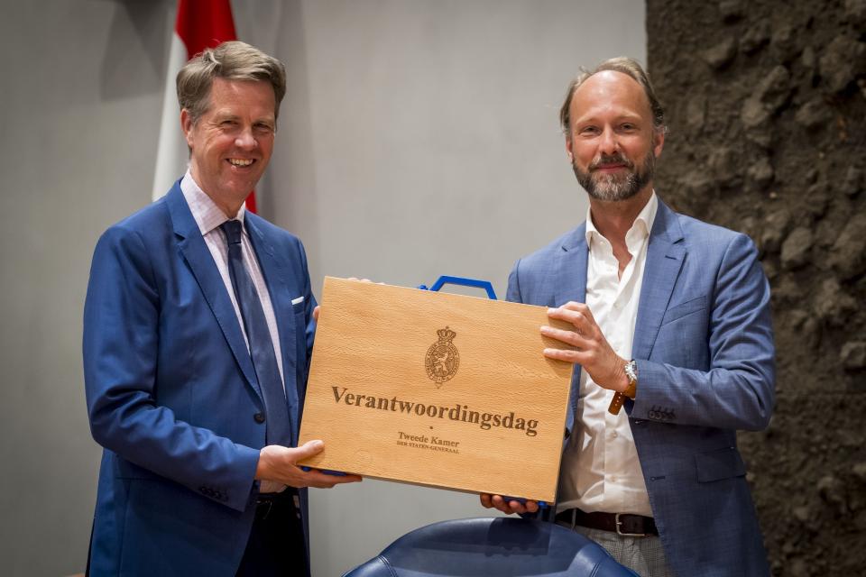 Kamervoorzitter Martin Bosma neemt een houten koffer in ontvangst van Sjoerd Hauptmeijer in de plenaire zaal.