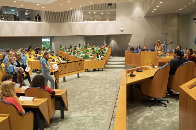 Jongeren in debat in de bankje van de plenaire zaal